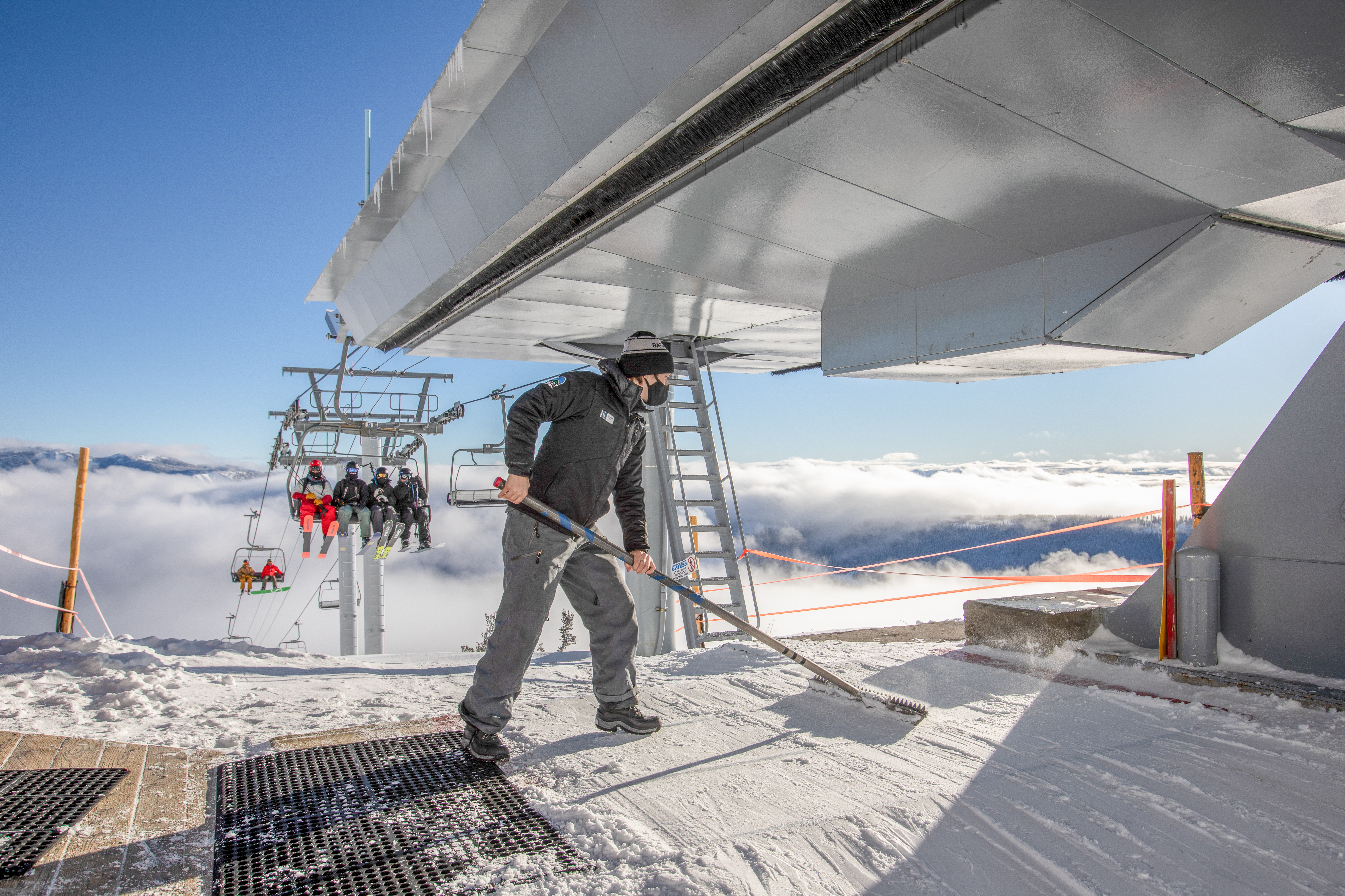 lift operator sweeps snow at big sky resort